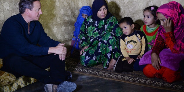 Sept. 14, 2015: Prime Minister David Cameron meets Syrian refugee families at a tented settlement camp on the Syrian - Lebanese border.