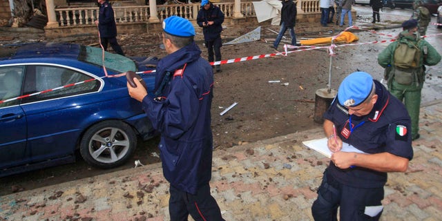Nov. 16, 2011: U.N. peacekeeper investigators, inspect the scene where a bomb exploded in the pub of the Queen Elissa Hotel, in the southern port city of Tyre.
