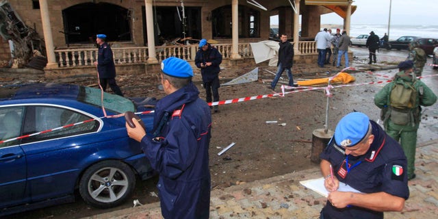 Nov. 16, 2011: U.N. peacekeeper investigators, inspect the scene where a bomb exploded in the pub of the Queen Elissa Hotel, in the southern port city of Tyre.