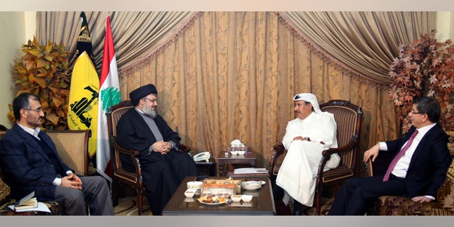 In this photo released by Hezbollah Media Office on Tuesday, Jan. 18, 2011, from left, Hussein Khalil, the political adviser to Hezbollah leader Sheik Hassan Nasrallah, listens as Nasrallah meets with Qatar's Prime Minister Sheikh Hamad bin Jassim bin Jabr Al-Thani and Turkish Foreign Minister Ahmet Davutoglu, in Beirut, Lebanon. Saudi Arabia has abandoned efforts to mediate in Lebanon's political crisis, removing a key U.S. ally from talks to ease tensions after Hezbollah toppled the government in Beirut last week.