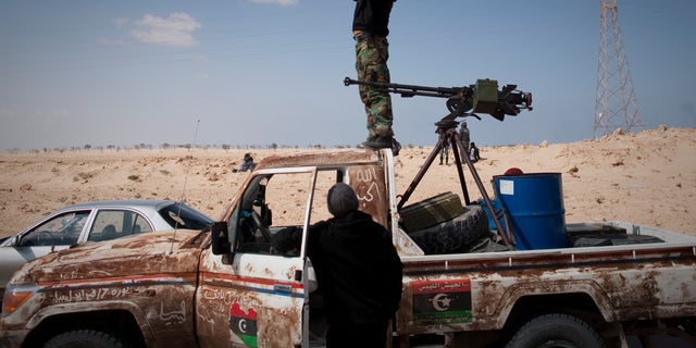 March 24: A Libyan rebel observes on a checkpoint the frontline near Zwitina, the outskirts of the city of Ajdabiya, south of Benghazi, eastern Libya. (AP)