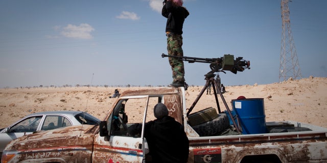March 24: A Libyan rebel observes on a checkpoint the frontline near Zwitina, the outskirts of the city of Ajdabiya, south of Benghazi, eastern Libya. (AP)