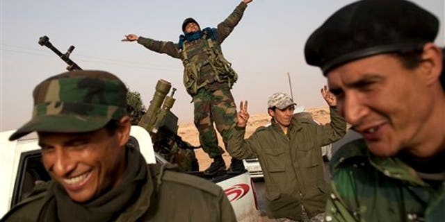 March 5: Libyan rebels who are part of the forces against Libyan leader Muammar Qaddafi celebrate their victory in fighting against troops loyal to Qaddafi, in the oil town of Ras Lanuf, eastern Libya (AP).