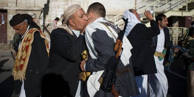 Yemenis exchange greetings after Eid al-Adha prayers attended by supporters Houthis Shiite rebels in the first day of the Muslim holiday of Eid al-Adha in Sanaa, Yemen, Saturday, Oct. 4, 2014. Muslims around the world celebrated Eid al-Adha Saturday to commemorate the willingness of the prophet Ibrahim - or Abraham as he is known in the Bible - to sacrifice his son in accordance with God's will, though in the end God provides him a sheep to sacrifice instead. The major Muslim holiday coincides this year with the Jewish holiday of Yom Kippur, the first time this has happened since 1981. (AP Photo/Hani Mohammed)