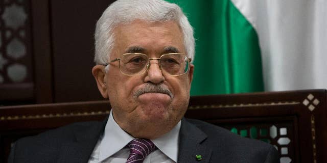 FILE - In this Wednesday, Sept. 16, 2015 file photo, Palestinian President Mahmoud Abbas makes comments to journalists on the ongoing unrest at the Al-Aqsa mosque compound in Jerusalem, in the West Bank city of Ramallah. Abbas' hopes of setting up a Palestinian state through negotiations with Israel have been derailed, and a new poll shows that a majority of Palestinians want Abbas to resign and dissolve his self-rule government, the Palestinian Authority. Many no longer believe setting up Palestine alongside Israel is realistic and support political violence. (AP Photo/Majdi Mohammed, File)