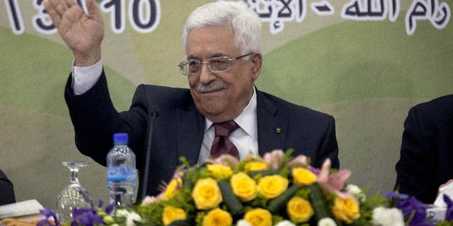 In this March 10, 2014 file photo, Palestinian President Mahmoud Abbas gestures during a meeting of the Fatah revolutionary council in the West Bank city of Ramallah. A long-running personal feud between Palestinian President Mahmoud Abbas and a former powerful operative in his Fatah movement has erupted into the open with public accusations of deceit and corruption. Abbas' hour-long tirade against the exiled Mohammed Dahlan signals the battle is heating up over who will one day succeed the 79-year-old president. (AP Photo/Majdi Mohammed, File)