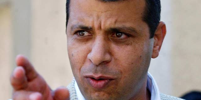 FILE - In this Aug. 23, 2004 file photo, former Palestinian security chief Mohammed Dahlan gestures prior to a meeting with leader Yasser Arafat at his compound in the West Bank town of Ramallah.A court has sentenced a leading rival of Palestinian President Mahmoud Abbas in absentia to two years in prison, effectively blocking him from a future leadership battle. The sentence against Mohammed Dahlan was handed down by a West Bank court in March, but was made public only Wednesday May 21, 2014 in the official Palestinian Authority newspaper. (AP Photo/Nasser Shiyoukhi, File)