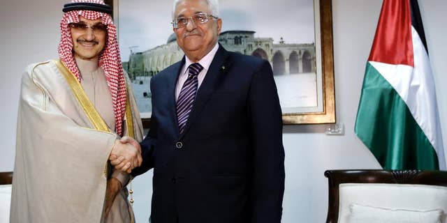 March 4, 2014 - Palestinian President Mahmoud Abbas, right, shakes hands with Saudi Prince Alwaleed bin Talal, during their meeting in the West Bank city of Ramallah.