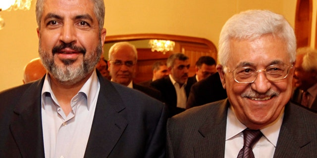 Nov. 24, 2011: Palestinian Hamas leader Khaled Mashaal, left, and Palestinian President Mahmoud Abbas are seen together during their meeting in Cairo, Egypt. (AP/Office of Khaled Meshaal, File)