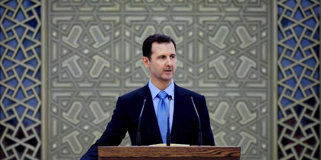 FILE - In this Wednesday, July 16, 2014 file photo released by the Syrian official news agency SANA, Syria's President Bashar Assad is sworn for his third, seven-year term, in Damascus, Syria. Assad said in remarks published Wednesday that U.S.-led airstrikes targeting Islamic State group militants in his country are neither serious nor efficient, claiming they have failed to produce any tangible results. (AP Photo/SANA, File)