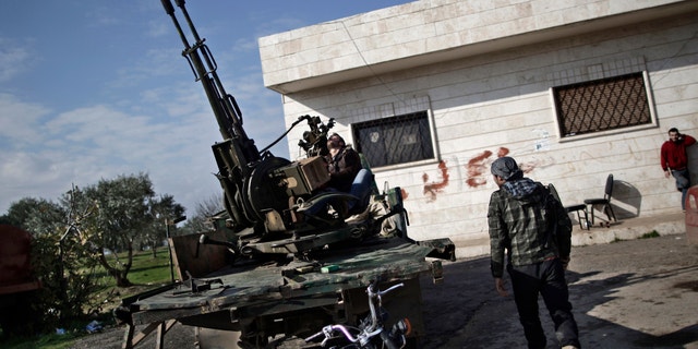 Dec. 14, 2012 - Syrian rebel checks an anti-aircraft weapon, in Maaret Misreen, near Idlib, Syria.