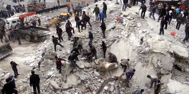 Feb. 3, 2013 - This citizen journalism image provided by Aleppo Media Center, shows people searching through the debris of destroyed buildings after airstrikes hit the neighborhood of Eastern Ansari, in Aleppo, Syria.