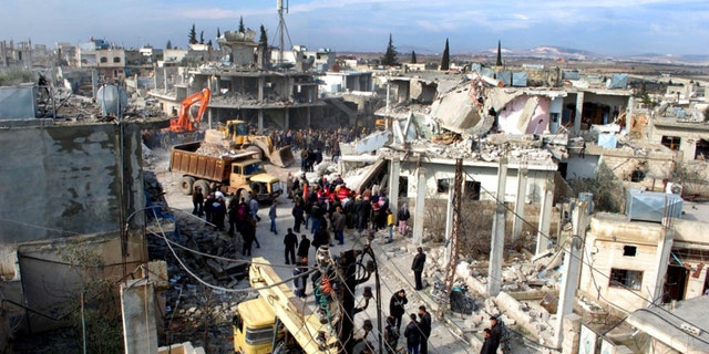 Jan . 9, 2010 - Syrian citizens gather where a car bomb exploded near a school, at al-Kaffat village in the central Hama province, Syria, killing several people and wounding dozens. (SANA)