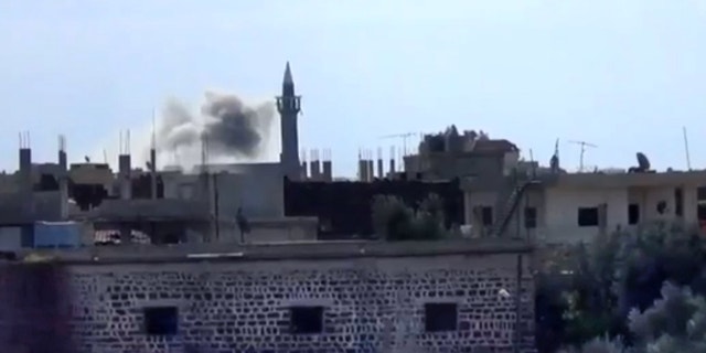 Jan. 24, 2013 - Image taken from video from the Shaam News Network: smoke rises from buildings due to heavy shelling in Daraa, Syria.