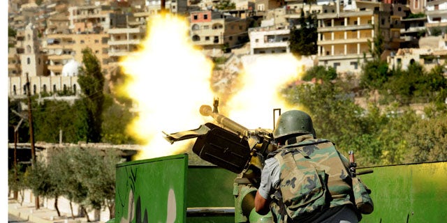 FILE -- In this Saturday, Sept. 7, 2013 file photo released by the Syrian official news agency SANA, a Syrian military solider fires a heavy machine gun during clashes with rebels in Maaloula village, northeast of the capital Damascus (AP Photo)