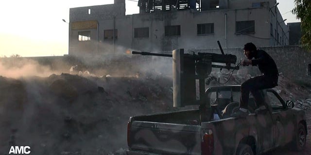 November 9, 2013: In this citizen journalism image, a Syrian rebel fires a weapon towards Syrian government troops loyal to President Bashar Assad in Aleppo, Syria. Activists said Syrian rebels have launched a counteroffensive in the northern city of Aleppo and recaptured a base near its international airport. (Aleppo Media Center)