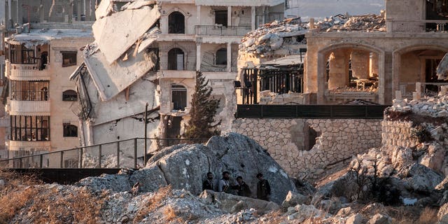 Syrian opposition fighters take cover in Telata village, in northwestern Syria, Sunday, Sept. 29, 2013.