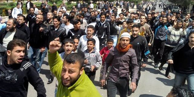 April 22: Syrian anti-government protesters shout slogans as they demonstrate following Friday prayers in the central city of Homs, Syria. (AP)