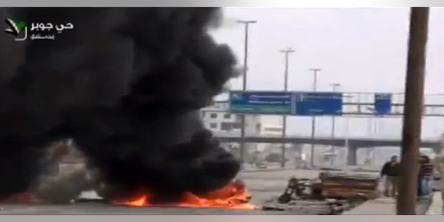 Feb. 8, 2013 - Image taken from video obtained from Ugarit News on Friday, shows smoke and fire rising on a main highway in Damascus, Syria.