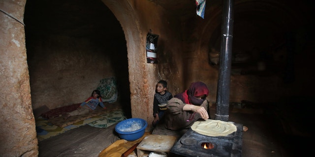 Feb. 28, 2013 - Nadia, 53, makes bread on a wooden stove, at an underground Roman tomb which she uses as a shelter with her family from Syrian government forces shelling and airstrikes.