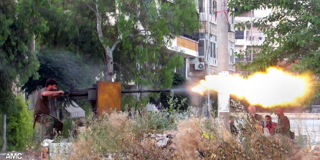 June 20, 2013 - A Syrian rebel firing a heavy machine gun towards Syrian soldiers loyal to Syrian president Bashar Assad, in Aleppo, Syria. (Citizen journalism image provided by Aleppo Media Center AMC.)