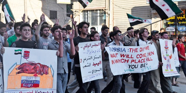 This citizen journalism image provided by Shaam News Network SNN, taken on Sunday, June 10, 2012 purports to show Syrians chanting slogans and holding posters, one with Arabic that reads, "the national council, was and still is the only legitimate representation for Syrian people," during a demonstration in Kfarnebel, Idlib province, northern Syria. Syrian activists say tens of thousands of people have been killed since the uprising began in March 2011. The situation has grown increasingly chaotic in recent months, and it is difficult to assign blame for much of the bloodshed. The government restricts journalists from moving freely, making it nearly impossible to independently verify accounts from either side. (AP Photo/Raed al-Fares, Shaam News Network, SNN)THE ASSOCIATED PRESS IS UNABLE TO INDEPENDENTLY VERIFY THE AUTHENTICITY, CONTENT, LOCATION OR DATE OF THIS HANDOUT PHOTO