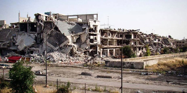 June 11, 2013 - Citizen journalism image provided by Lens Young Homsi, buildings destroyed from Syrian forces shelling in Homs province, Syria.