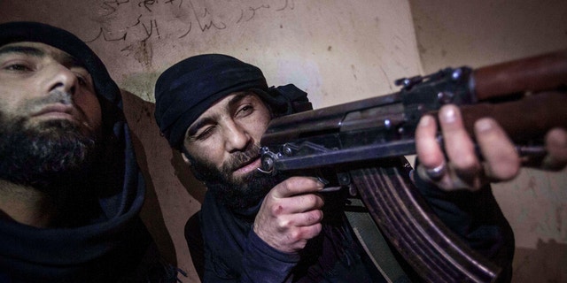 Dec. 5, 2012 - Free Syrian Army fighter aims his weapon during heavy clashes with government forces in Aleppo, Syria.