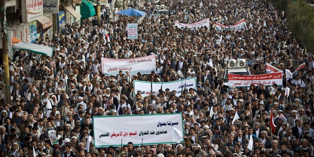 April 10, 2015: Shiite rebels, known as Houthis, gather during a protest against Saudi-led airstrikes in Sanaa, Yemen. The banner at the front reads: 'Steadfast against the savage Saudi American aggression.' (AP Photo/Hani Mohammed)