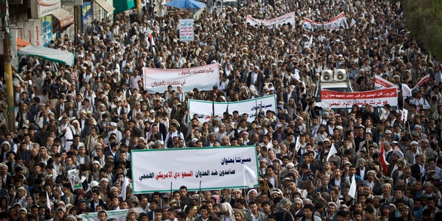April 10, 2015: Shiite rebels, known as Houthis, gather during a protest against Saudi-led airstrikes in Sanaa, Yemen. The banner at the front reads: 'Steadfast against the savage Saudi American aggression.' (AP Photo/Hani Mohammed)