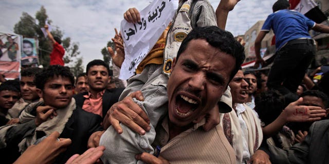 March 13, 2011: An anti-government protestor shouts during a demonstration demanding the resignation of Yemeni President Ali Abdullah Saleh, in Sanaa, Yemen.