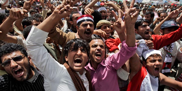 Anti-government protestors, shout slogans during a demonstration demanding the resignation of Yemeni President Ali Abdullah Saleh, in Sanaa, Yemen, Saturday, May 7, 2011.