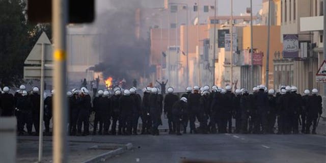 Jan. 1, 2012: Riot police and Bahraini anti-government protesters face off in the Shiite Muslim village of Sitra.