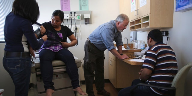 FORT COLLINS, CO - MAY 02: A family of asylum immigrants from Myanmar receives a health checkup at the Salud Family Health Clinic on May 2, 2013 in Fort Collins, Colorado. The non-profit provides low-cost health services to asylum immigrants as well as migrant farm workers, many of whom have no other access to healthcare, throughout northeastern Colorado. Healthcare for immigrants has become a major issue in immigration reform proposals. (Photo by John Moore/Getty Images)