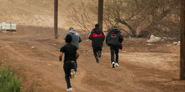 YUMA, AZ - MARCH 16: Men run after crossing illegally into the U.S. from Mexico on March 16, 2006 at the border town of near San Luis, south of Yuma, Arizona. As Congress begins a new battle over immigration policy, U.S. Customs and Border Protection (CBP) border patrol agents in Arizona are struggling to control undocumented immigrants that were pushed into the region by the 1990's border crack-down in California called Operation Gatekeeper. A recent study by the Pew Hispanic Center, using Census Bureau data, estimates that the U.S. currently has an illegal immigrant population of 11.5 million to 12 million, about one-third of them arriving within the past 10 years. More than half are reportedly from Mexico. Ironically, beefed-up border patrols and increased security are reportedly having the unintended result of deterring many from returning to their country of origin. (Photo by David McNew/Getty Images)