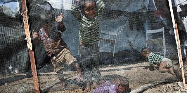 Children play inside the Moria refugee camp on the northeastern Aegean island of Lesbos, Greece. The jammed camp serves as a sober reminder to European leaders that their statistical success in curbing migration into the continent has spawned what the U.N. and others condemn as massive humanitarian failures.