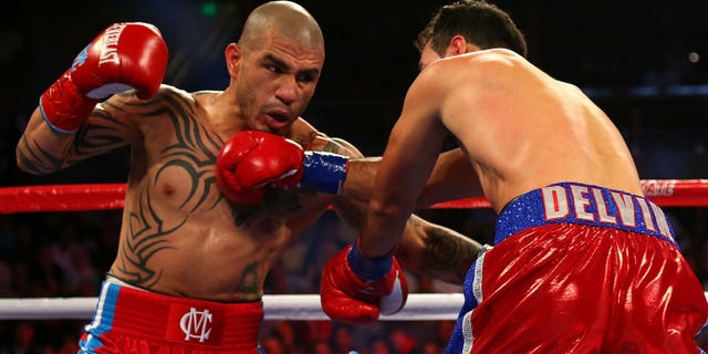 ORLANDO, FL - OCTOBER 05: Miguel Cotto throws a punch against Delvin Rodriguez during a Super Welterweight bout at Amway Center on October 5, 2013 in Orlando, Florida. (Photo by Mike Ehrmann/Getty Images)