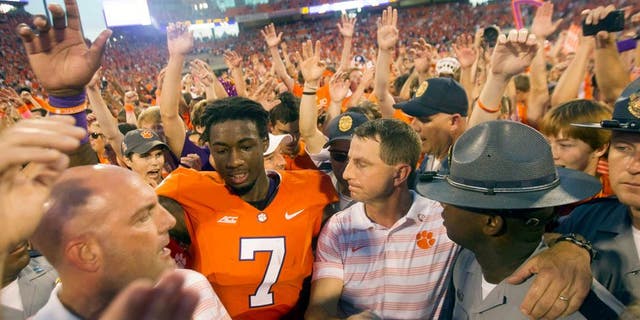 Oct 11, 2014; Clemson, SC, USA; Clemson Tigers wide receiver Mike Williams (7) celebrates with head coach Dabo Swinney (center right) after the game against the Louisville Cardinals at Clemson Memorial Stadium. Tigers won 23-17. Mandatory Credit: Joshua S. Kelly-USA TODAY Sports
