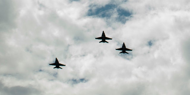 CINCINNATI, OH - AUGUST 31: In this handout photo provided by NASA, U.S. Navy F/A-18 jets from Strike Fighter Squadron (VFA) 106 and Strike Fighter Squadron (VFA) 34, from Naval Air Station Oceana (Va.) fly in a "Missing Man" formation over the Camargo Club following a memorial service celebrating the life of Neil Armstrong on August 31, 2012 in Cincinnati, Ohio. Armstrong, the first man to walk on the moon during the 1969 Apollo 11 mission, died Saturday, August 25. He was 82. (Photo by Bill Ingalls/NASA via Getty Images)