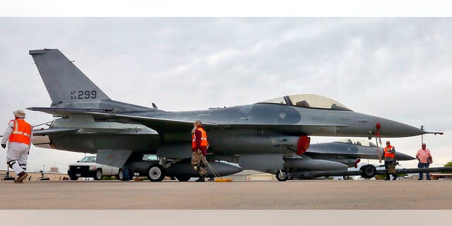 In this May 15, 2015, file photo, a boneyard crew tows an F-16 Fighting Falcon aircraft prior to the preservation process after its arrival at the 309th Aerospace Maintenance and Regeneration Group at Davis-Monthan Air Force Base in Tucson, Ariz. Military officials confirm a single F-16 Fighting Falcon aircraft crashed Wednesday night, June 24, 2015, about 5 miles east of Douglas Municipal Airport.