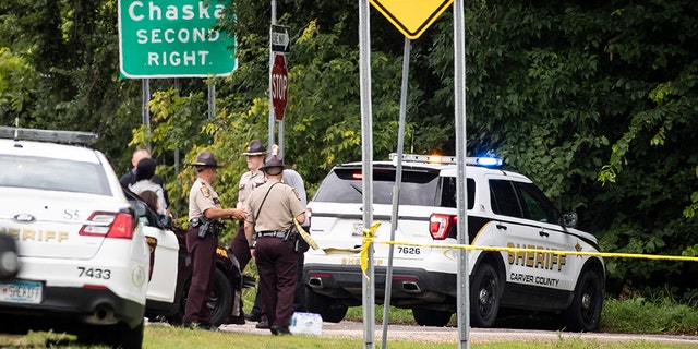 Investigators work the scene of an officer-involved shooting in Chanhassen, Minn., on Friday that left a 16-year-old boy dead.