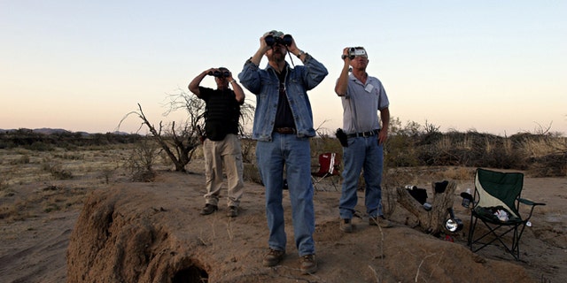 THREE POINTS, AZ - APRIL 1: (L-R) Minutemen Tony Ford, Vic Roman and Jeff Almli continue to search for a group of 12 undocumented immigrants after Roman spotted them from their post in the Altar Valley April 1, 2006 in the Sonoran Desert 35 miles south of Tucson, Arizona. Roman reported sighting the immigrants who were later captured by the Border Patrol. Approximately 100 volunteers from several states came to Arizona to participate in the third month-long action near the U.S. and Mexican borders searching for those entering the country illegally. Minutemen will also be stationed near the border with California, New Mexico and Texas. Chris Simcox, the leader of the Arizona Minutemen announced that there are now 7,000 registered Minutemen throughout the U.S. (Photo by Jeff Topping/Getty Images)