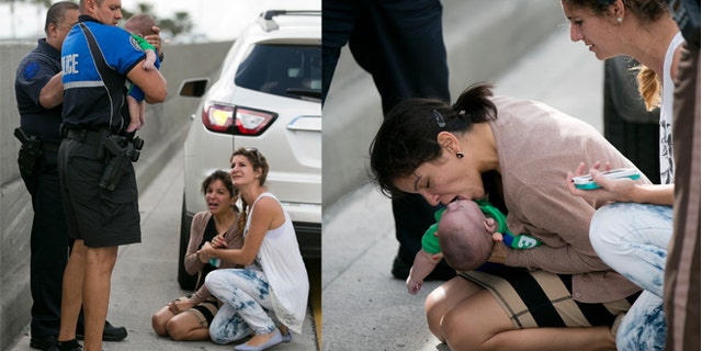 Pamela Rauseo, 37, performs CPR on her nephew, five-month-old Sebastian de la Cruz, after pulling her SUV over on the side of the road along the west bound lane on Florida state road 836 just east of 57th Avenue around 2:30pm on Thursday, Feb. 20, 2014. At right is Lucila Godoy who stopped her car to assist in the rescue. The baby was rushed to Jackson Memorial Hospital, where he is reportedly doing ok. (AP Photo/The Miami Herald, Al Diaz)