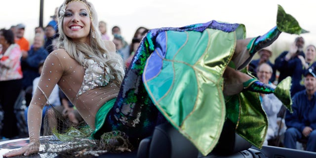 FILE - In this Sept. 14, 2013 file photo Miss New Jersey Cara McCollum displays her shoes during the Miss America Shoe Parade at the Atlantic City, N.J. boardwalk. McCollum was critically injured when her convertible spun off a highway and hit a tree, state police said Tuesday. (AP Photo/Julio Cortez, File)