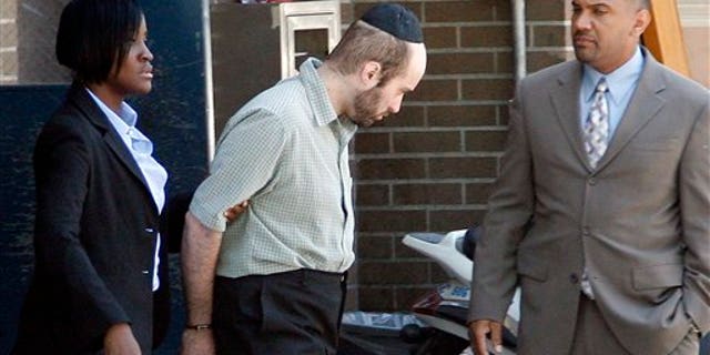 July 14: Detectives walk Levi Aron, center, to a police car at the Brooklyn borough of New York's 67th precinct.