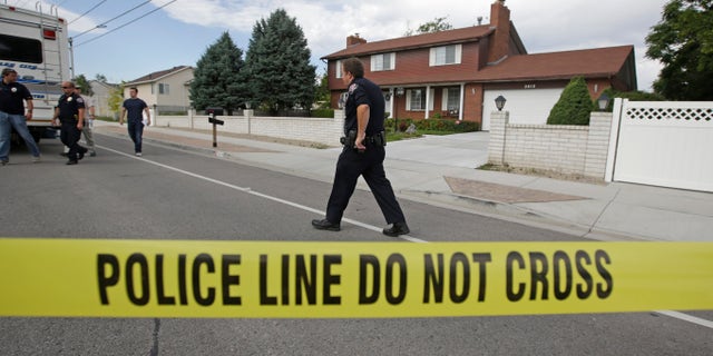 Police officials gather during an investigation after a 12-year-old girl was found dead Friday, July 17, 2015, in West Valley City, Utah. The search for the missing 12-year-old girl is now being investigated as a homicide after West Valley City police discovered the girl's body in a horse pasture. Police Chief Lee Russo says the girl's mother approached two officers at a convenience store near their home around 1:30 a.m. Friday,July 17, 2015. She told officers her daughter had been missing since midnight. (AP Photo/Rick Bowmer)