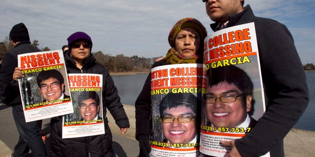 Feb. 27, 2012: Luzmila Garcia, of Newton, Mass., center right, mother of missing Boston College student Franco Garcia, displays a placard of her son along with Franco's aunt Carmen Espinoza, left, and his cousin Pablo Marchena, right, at the Chestnut Hill Reservoir where Mass. state police are searching the water for the missing student, in Boston. Garcia, 21, has not been seen since early Wednesday, at a bar popular with Boston College students near campus.