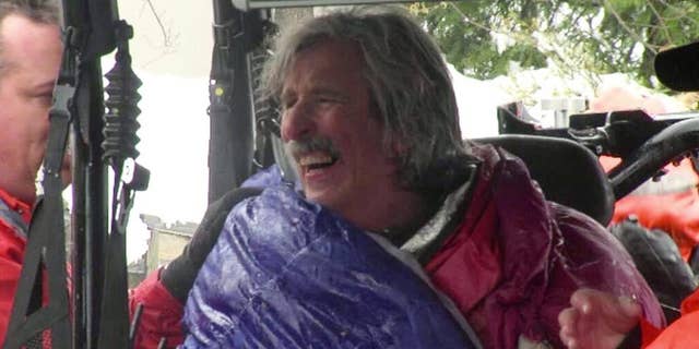 This image from video provided by KTXL Fox 40 Sacramento, shows trail runner Robert Root after being rescued Tuesday, April 1, 2014, near Foresthill, Calif., in Placer County. Root was found alive in snowy conditions, two days after he went missing near a trail in a mountainous region of Northern California, authorities said. Root, 55, of Modesto, Calif., was wearing only a light running shirt, shorts and running shoes when he was discovered by rescuers on the Western States trail. (AP Photo/KTXL Fox 40 Sacramento)