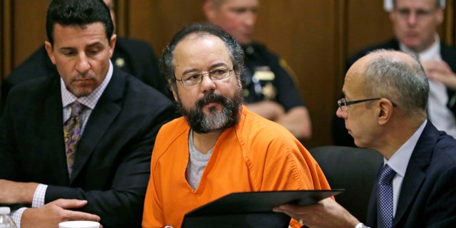 Aug. 1, 2013: Ariel Castro, center, listens in the courtroom during the sentencing phase of his trial, in Cleveland. Defense attorney's Craig Weintraub, left, and Jaye Schlachet sit beside Castro.
