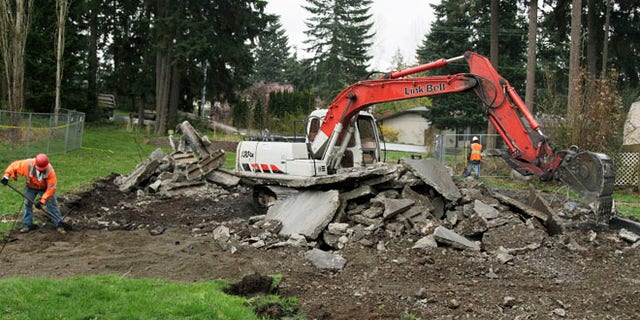 April 11: Demolition workers remove what is left of the fire-damaged home where Josh Powell killed himself and his two sons on Feb. 5, 2012. in Graham, Wash.